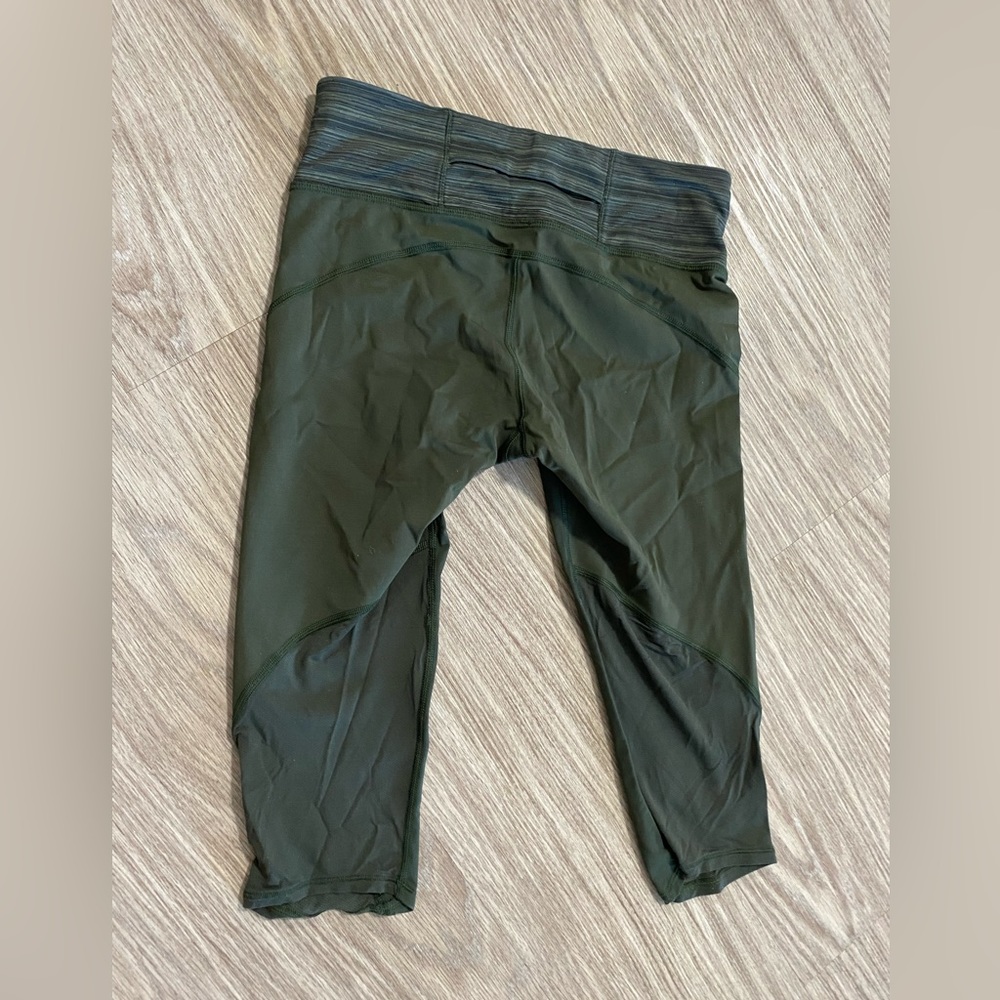 Olive green lululemon capris with neon pink detailing on sides. - Picture 2 of 2